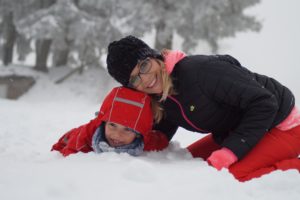 Mother and son playing in the snow
